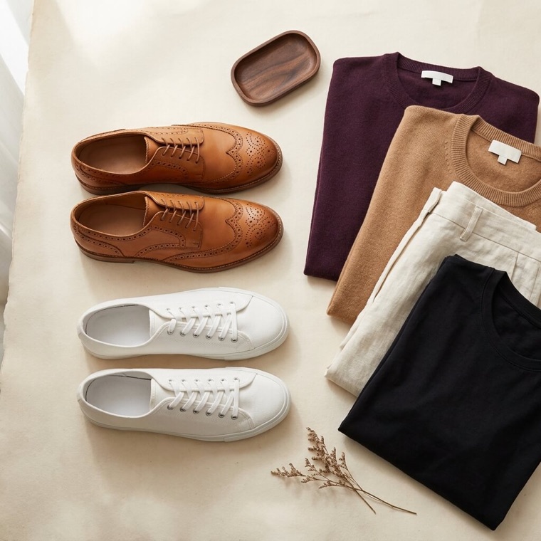 Tan leather shoes beside white trainers